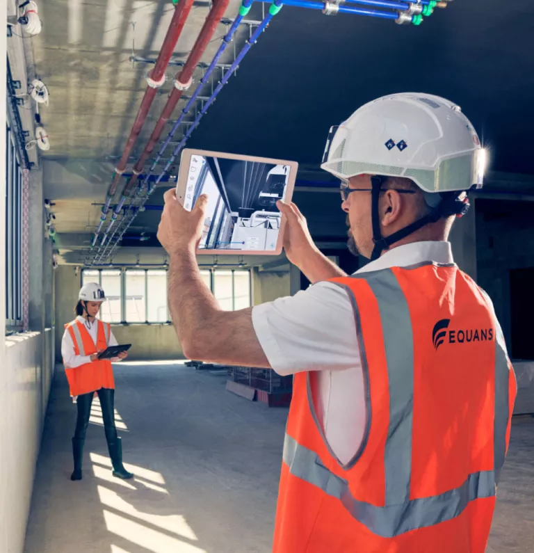 Technician with an ipad checking controls fo a facility