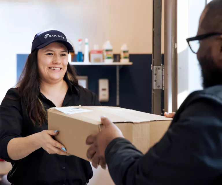 employee giving a box to another employee