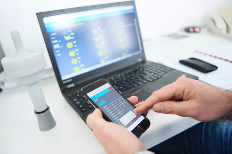 techician working on a computer and on a tablet