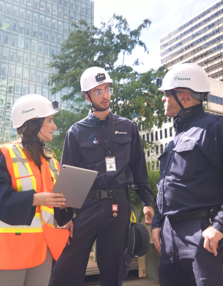 Three colleague analyzing the consumption of a building in a city