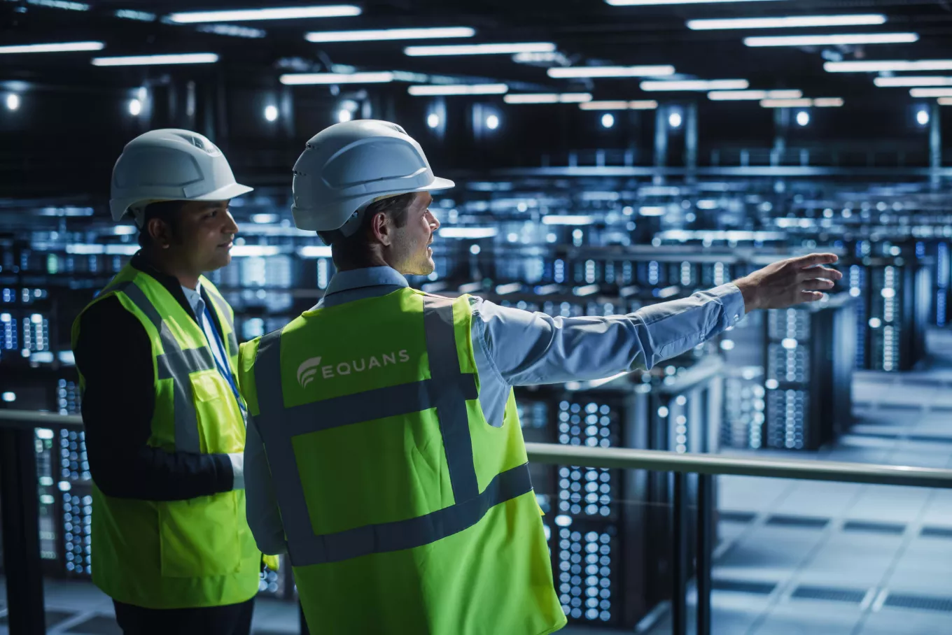 two technicians looking over a big data center facility