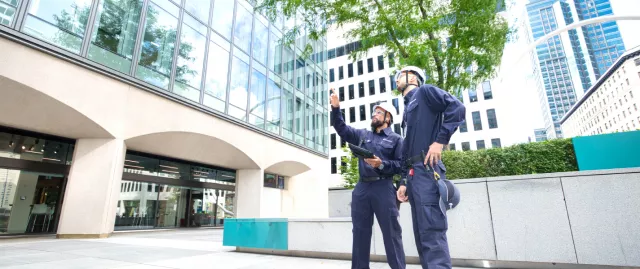 two technician observing a building outside