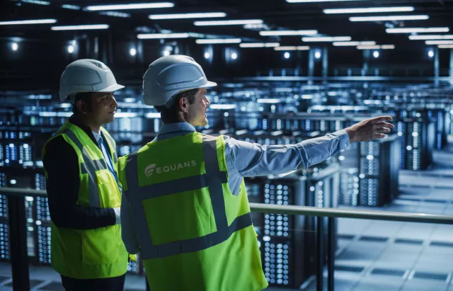 two technicians looking over a big data center facility